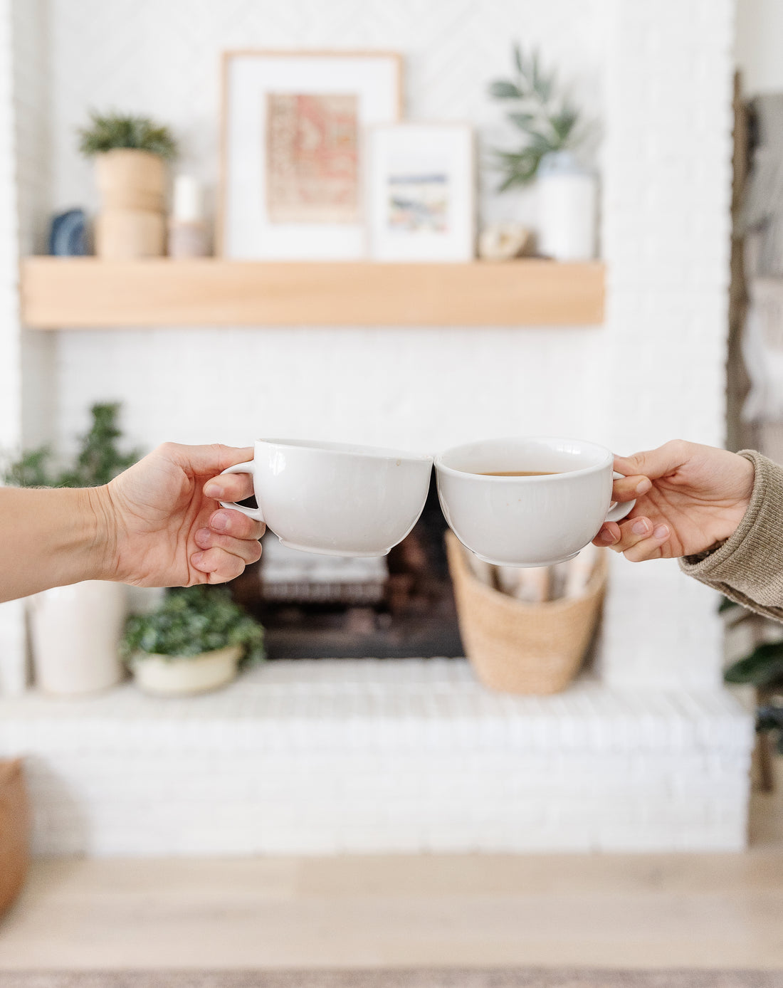 Coffee mug cheers at home in front of fireplace