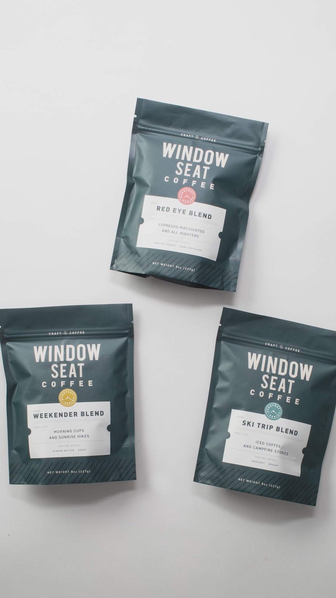 GIF of three 8oz bags of whole bean roasted coffee from Window Seat Coffee, including weekender blend, red eye blend, and ski trip blend
